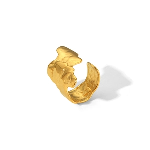 Detailed close-up of golden adjustable ring with irregular lava hammered texture