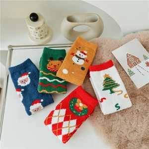 Five pairs of thick Christmas coral fleece socks with festive patterns on a cozy background