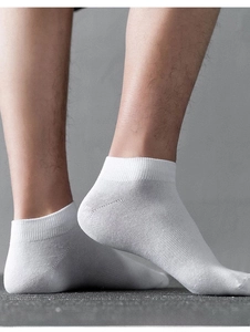 Detail of white cotton ankle sock featuring a ribbed anti-slip cuff for a secure fit