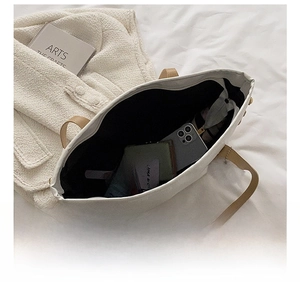 Interior view showing the large capacity of the tote bag with daily essentials inside