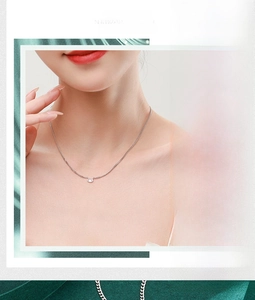Close-up of minimalist S925 silver necklace with an oval-cut shimmering solitaire pendant