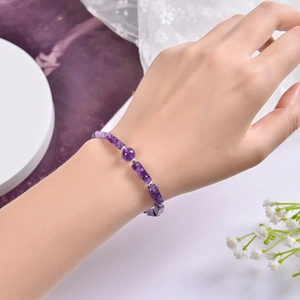 Detailed close-up of natural purple amethyst bracelet with rectangular beads on model wrist