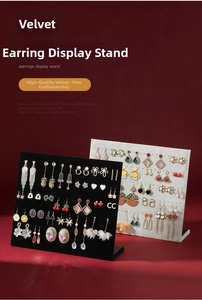 L-shaped velvet earring display boards in black and grey on dark red background