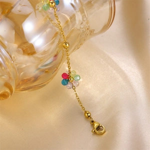 Close-up of golden chain with colorful beaded daisy flowers and secure lobster clasp