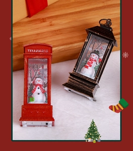 Detail view of festive Santa Claus telephone booth and retro lantern with snowman scenery