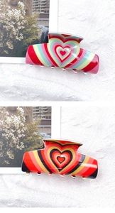 Detail of cute heart pattern hair claws in colorful acrylic material and glass finish
