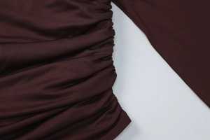 Detail view of the elegant ruched side design on the wine red slim-fit skirt fabric