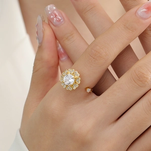 Rotating floral 18K gold open ring with heart petals and sparkling cubic zirconia center