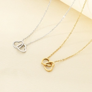 Close-up of interlocking heart pendants in silver and gold finish on 18K plated chain