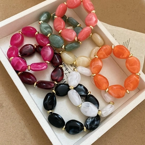 Detail showing irregular acrylic oval beads in multiple colors with gold spacers