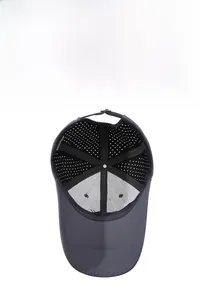 Detailed macro view of dark grey breathable laser-cut holes on a sporty baseball cap