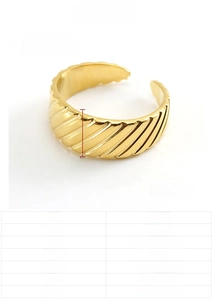 Detail of 8mm wide 18K gold plated stainless steel ring with elegant diagonal grooves