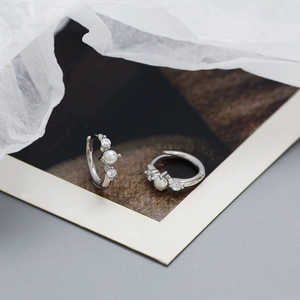 Detailed close-up of S925 silver hoop earrings featuring pearls and cubic zirconia stones