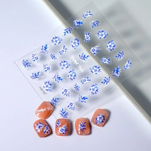 Detailed relief texture of blue floral nail art stickers with 3D embossed flower patterns