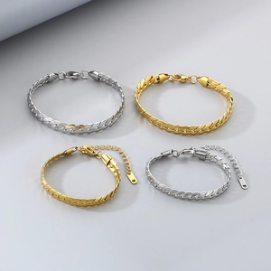 Detailed close-up of gold and silver flat weave Cuban link chains with lobster clasps