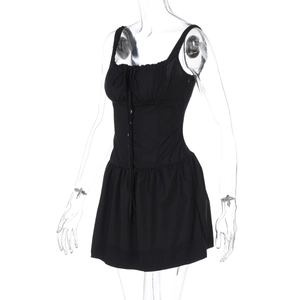 Detail view of black slim fit mini dress with ruched neckline and front tie design