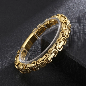 Detailed macro view of gold Byzantine chain bracelet on a textured black box stand