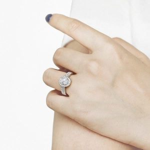 Close-up of elegant 925 sterling silver halo ring with oval cubic zirconia on hand