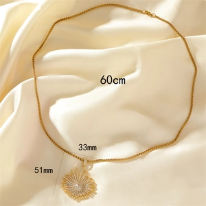 Gold sunburst pendant necklace with zircon inlay on silk background, 60cm chain length