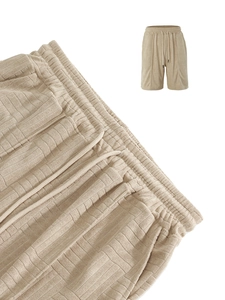 Detailed macro view of khaki waffle knit shorts featuring elastic drawstring waistband