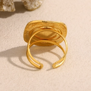 Detail of 18K gold plated square signet ring with textured shell inlay and open band