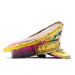 Macro detail of holographic leather party hat with golden sequins and spiked studs