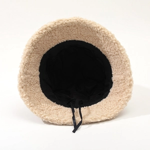 Detail of lamb wool bucket hat interior featuring black lining and adjustable drawstring