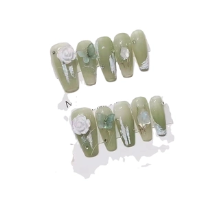 Handmade light green gradient press-on nails with 3D white roses and butterfly accents