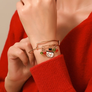 Detail of adjustable Christmas bracelet with snowman charm and festive beads on wrist