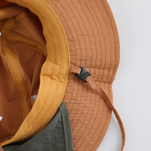 Detailed close-up showing the adjustable chin strap and quick-dry fabric of the sun hat.
