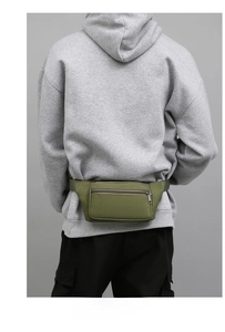 Close-up of olive green nylon waist bag with double zippers worn by a model in casual attire