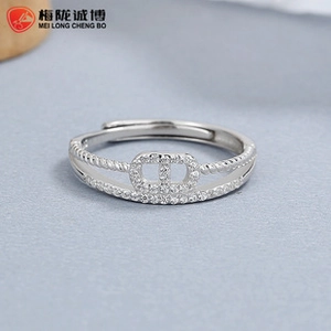 Macro shot of silver CD logo ring with pave zircon crystals and twisted band detail