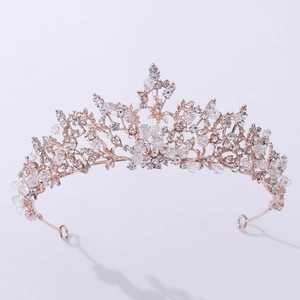 Close-up of rose gold bridal crown with crystal flower motifs and intricate rhinestones