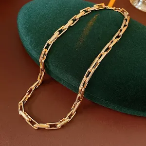 Adjustable golden link chain necklace with rectangular links on a velvet stand