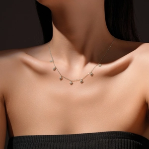 S925 sterling silver necklace featuring delicate star pendants on a model's neck