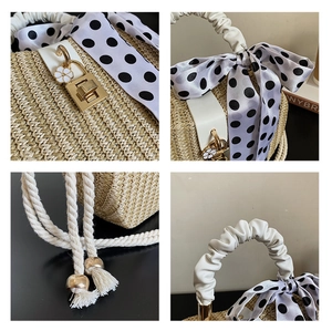 Detail view of woven straw bag with silk ribbon, gold lock, and flower charm details