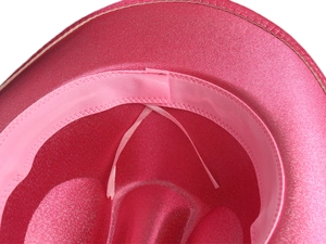 Macro detail of sparkly rose pink hat interior showing sweatband and adjusting ribbons