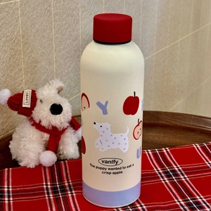 Detailed view of insulated bottle on checkered tablecloth with cozy plush decor