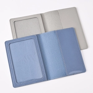 Detail view of open PU leather passport covers in grey and blue with card slots