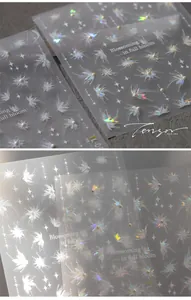 Detailed macro view of 3D embossed butterfly nail stickers with pearls and holo flowers