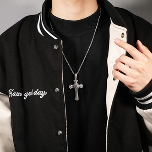 Detail of hip hop cross pendant with micro-paved zircons on a silver rope chain