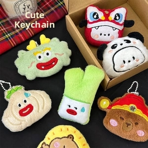 Detailed plush keychain charms including panda, lion dance, and bear with lucky cap