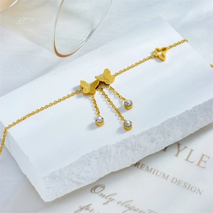 Gold-plated stainless steel butterfly anklet with sparkling rhinestones and chain tassels
