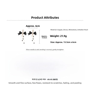 Detail of black bow earrings with pearl tassels and dimensions 13.5cm by 6cm