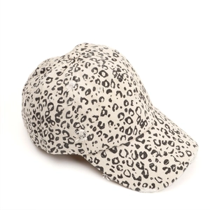 Detail of distressed ripped brim and leopard print pattern on vintage baseball cap