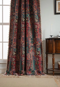 Detail of bohemian geometric pattern curtain with decorative white fringe tassels