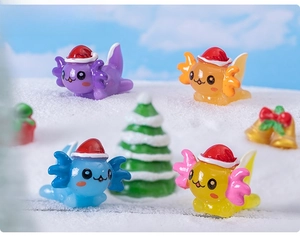 Miniature Christmas axolotl resin figurines in festive snow scene with tiny ornaments