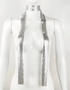 Detailed view of shimmering silver metal sequin choker and chainmail scarf on a mannequin