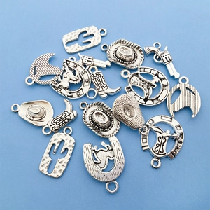Macro shot of silver western style charms featuring cowboy hats and cactus elements