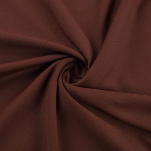 Macro shot of dark brown knitted fabric showing elastic texture and soft drape detail